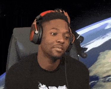 a man wearing headphones is sitting in front of a screen that shows the earth