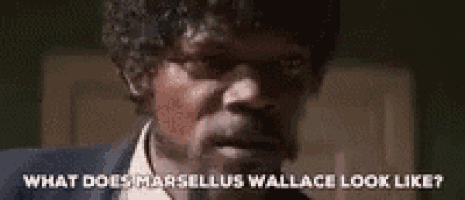 a close up of a man 's face with the words `` what does marsellus wallace look like '' written above him .