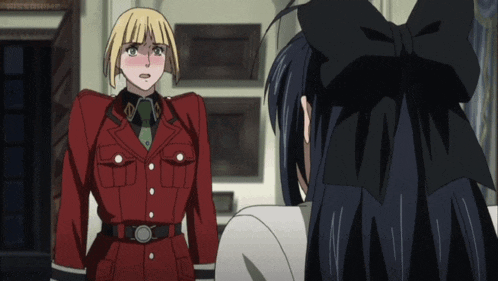 a man in a red uniform stands next to a woman in a black bow