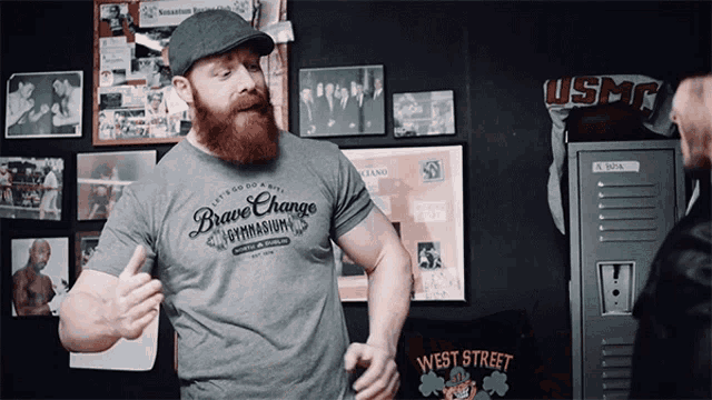 a man with a beard wears a shirt that says brave change gymnasium