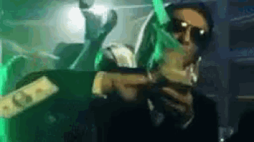 a man in sunglasses is holding a bunch of money in his hands .