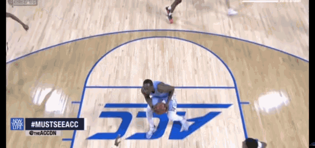 a basketball game is being played on a court with the acc logo