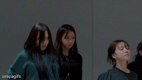 a group of women are dancing in a dark room with the words aespagifs in the bottom right corner