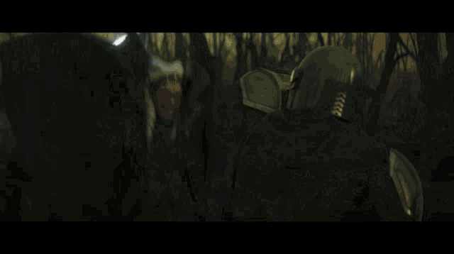 a man and a woman are standing next to each other and the woman is holding a light saber