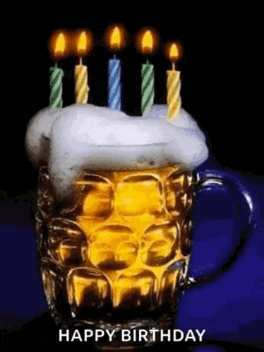 a beer mug with candles on top of it and the words `` happy birthday '' written below it .