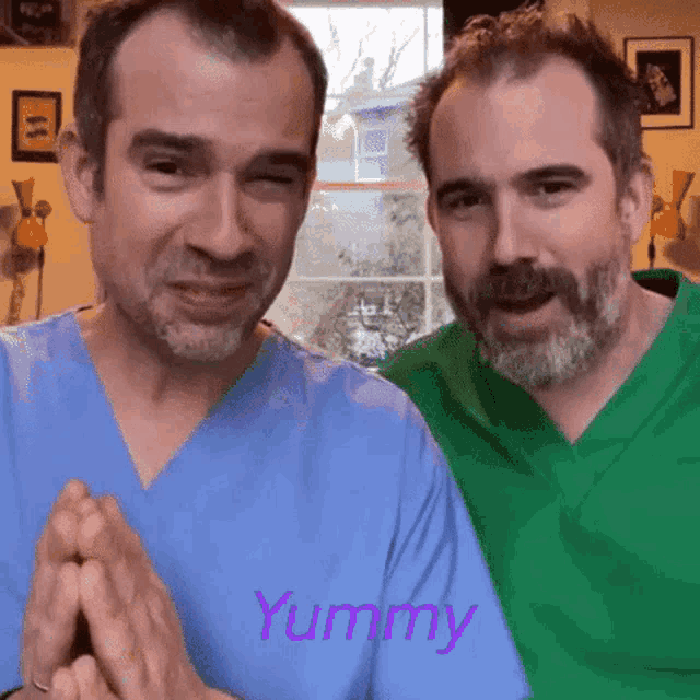 two men wearing scrubs are standing next to each other with the word yummy written on the bottom