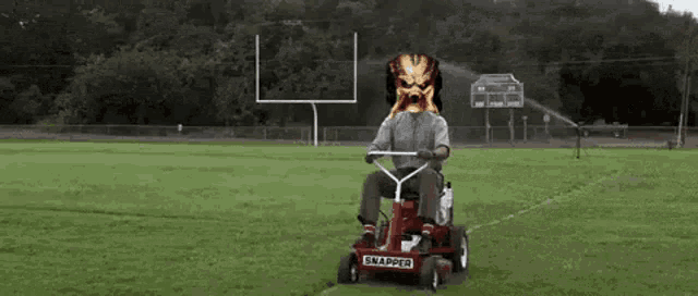 a man is riding a snapper lawn mower on a field