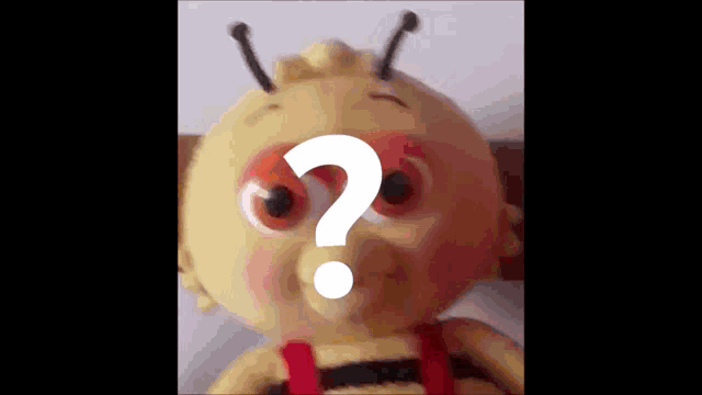 a stuffed bee with a question mark behind it