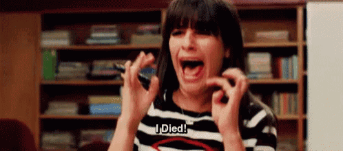 a woman in a striped shirt is screaming and holding a pen .