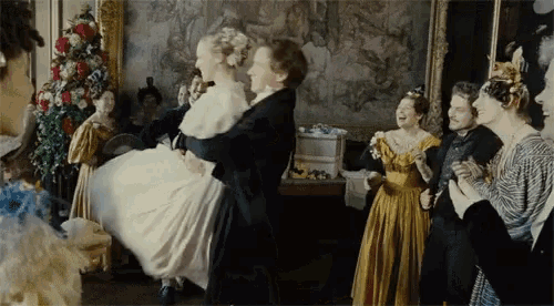a man is holding a woman in his arms in a room