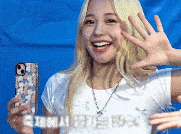 a woman in a white shirt is holding a phone with a case that says casetify