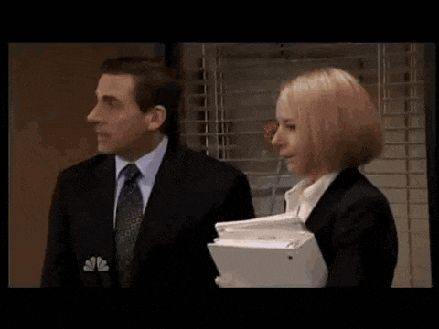 a man in a suit and tie is shaking hands with a woman in a suit .
