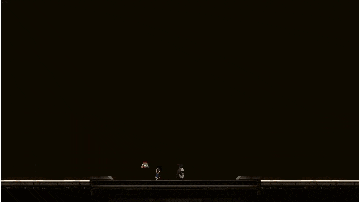 a person is standing in a dark room with a red laser beam coming out of the ceiling .