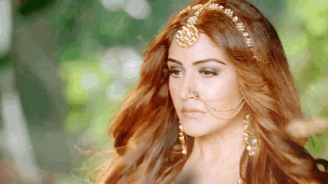 a close up of a woman wearing a nose ring and a headband