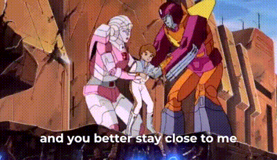 a group of transformers are standing next to each other and holding a child in a cartoon .