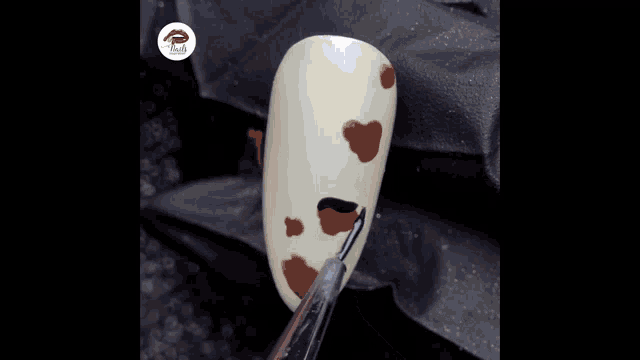 a plastic container filled with pearls and rhinestones with a lipstick logo in the background