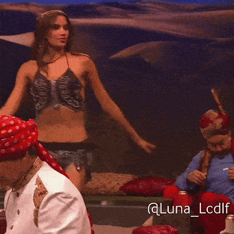 a woman in a bikini is dancing with a man in a bandana and the hashtag @luna_lcdlf