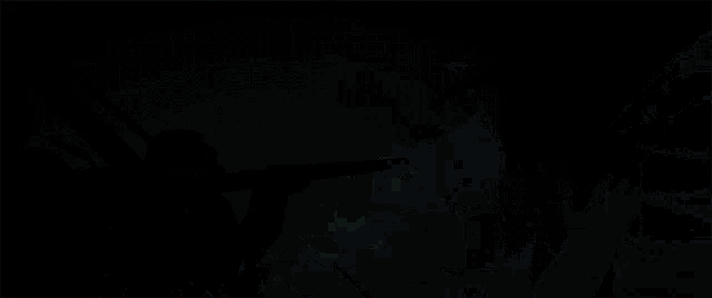 a man in a gas mask is holding a gun while another man is flying in the air