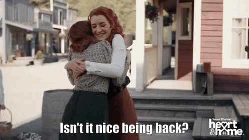 two women hugging with the words isn t it nice being back on the bottom