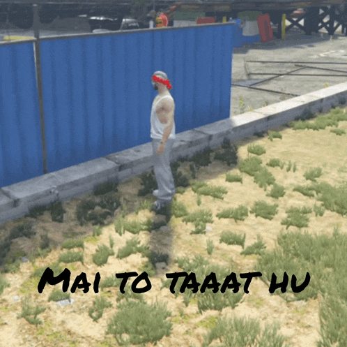 a man wearing a bandana stands in a field with the words mai to taaat hu written on the ground