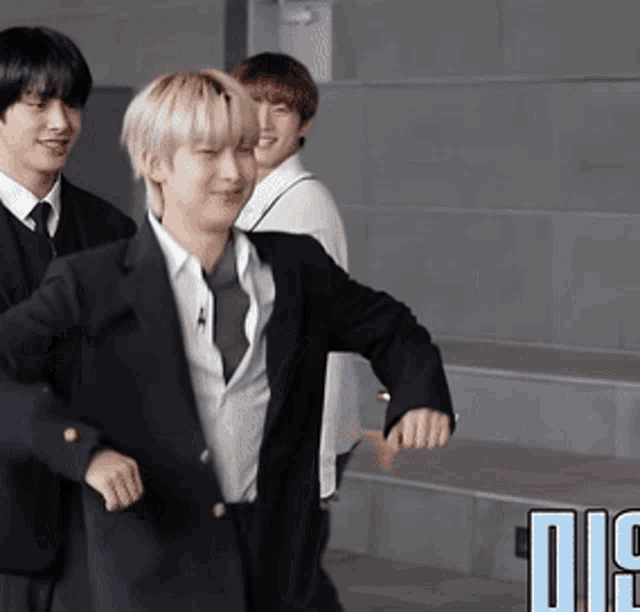 a man in a suit and tie is standing next to another man in a suit