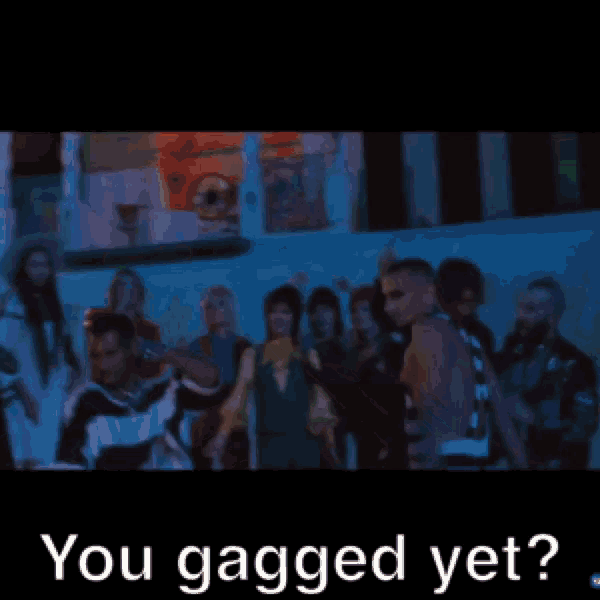 a man without a shirt is being held by a woman with the words " you gagged yet " written below him