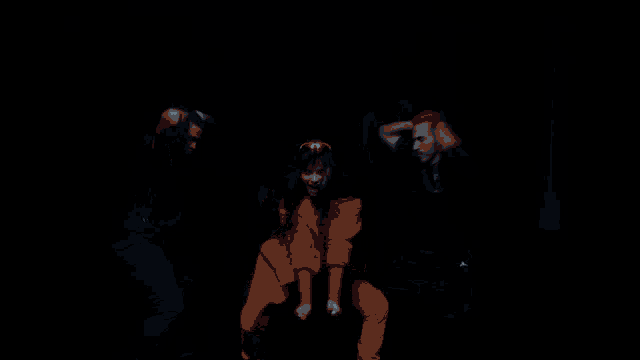 a woman in a red jacket is dancing with two men