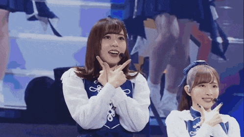 a girl with a microphone on her head is making a peace sign