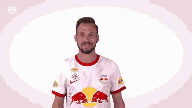 a man is wearing a red bull jersey