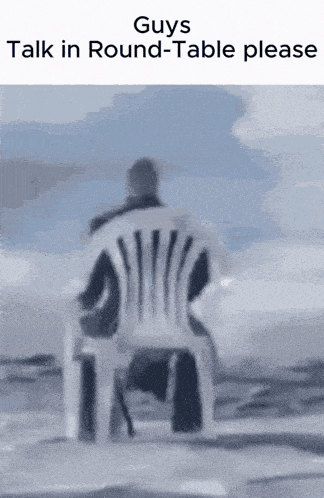 a man is sitting in a chair with the words " guys talk in round-table please " above him