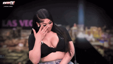 a woman covering her face in front of a sign that says las vegas tv