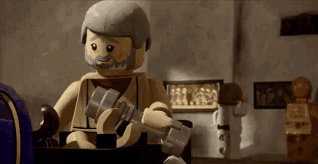a lego figure with a beard is holding a hammer