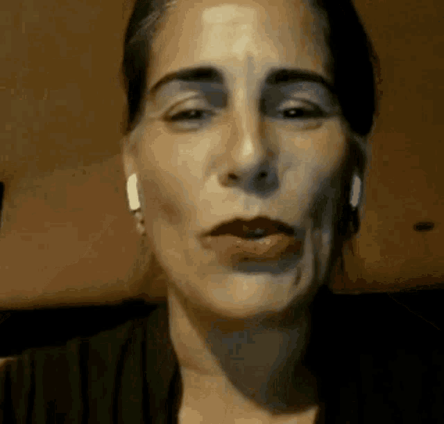 a close up of a woman 's face wearing headphones .