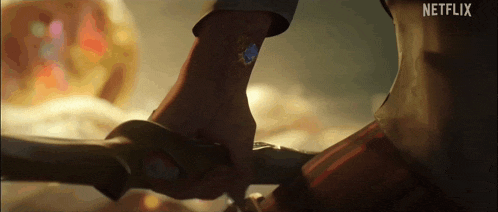 a close up of a person 's hand holding a sword with netflix written on the bottom