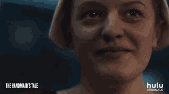 a close up of a woman 's face with the words " the handmaid 's tale " on the bottom