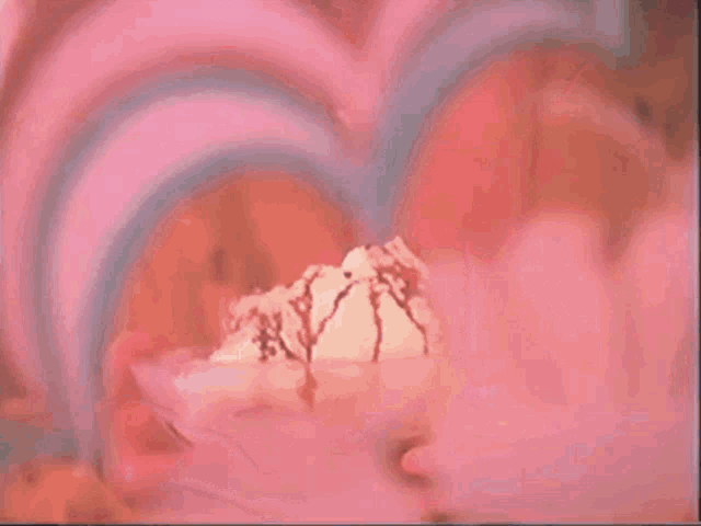 a close up of a woman 's face with a pink background