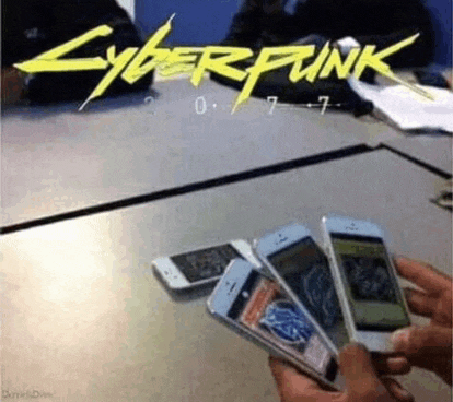a person is holding four cell phones in front of a cyberpunk 2077 poster