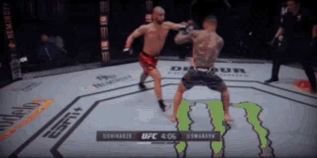 two men are fighting in a boxing ring with a monster on the ground