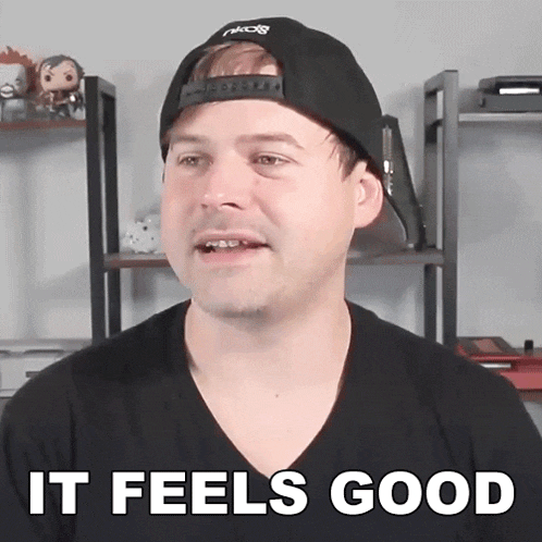 a man wearing a hat and a black shirt says " it feels good "