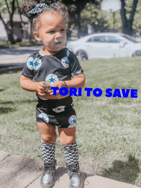 a little girl is standing on a sidewalk with the words " tori to save " behind her