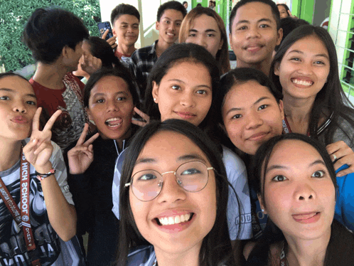 a group of young people posing for a picture with a lanyard that says high school on it