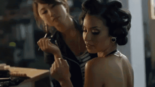 a woman with curlers in her hair is getting her makeup done
