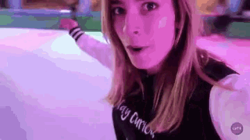 a woman wearing a black sweater that says lazy cutie on it