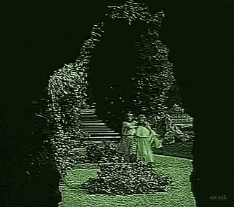 a black and white photo of two women standing next to each other in a park .