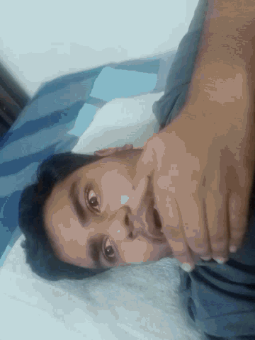 a man with a surprised look on his face covering his mouth with his hands