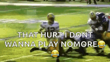 a group of football players are playing a game on a field and one of them is kneeling down .