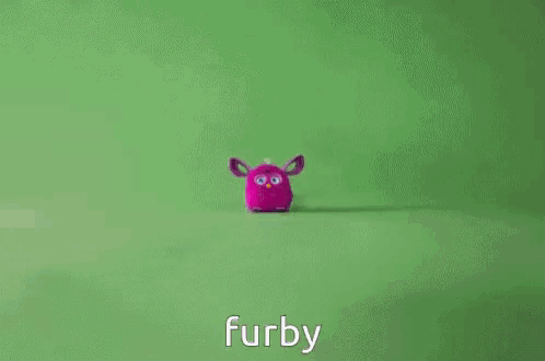 a close up of a purple furby toy with blue eyes
