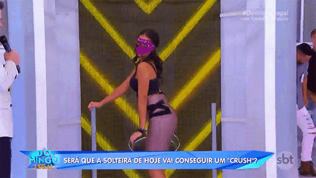 a woman wearing a mask is on a sbt television show