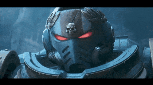 a close up of a space marine 's helmet with red eyes and a skull on it