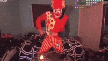 a man dressed as a clown is holding a gun in a room with the number 529/525 on the bottom